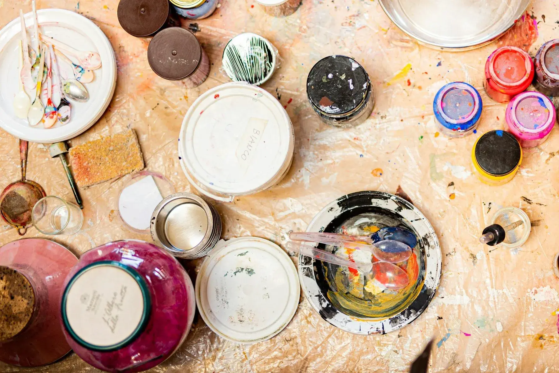 Paint pots and brushes on a table