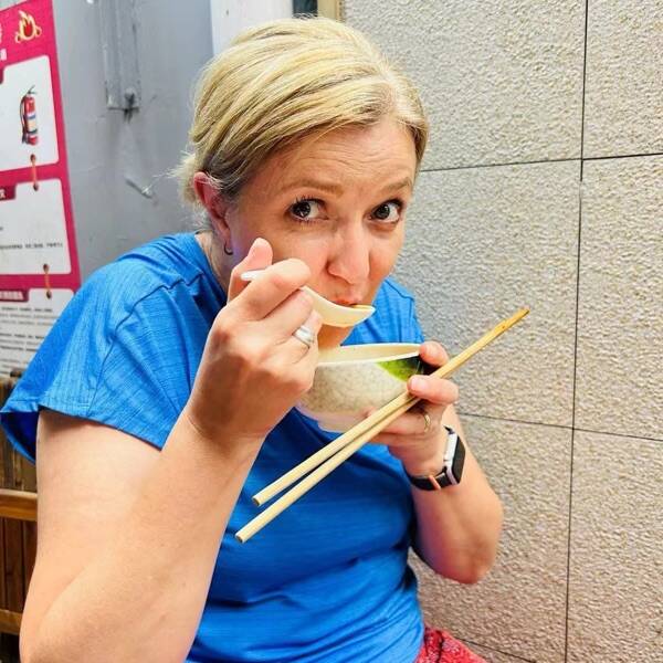 Karen tasting a fresh dan hong gao at a neighborhood stall