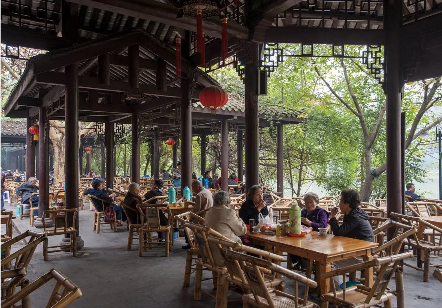 Bamboo chairs and covered tea tables at a traditional Chengdu teahouse in People's Park