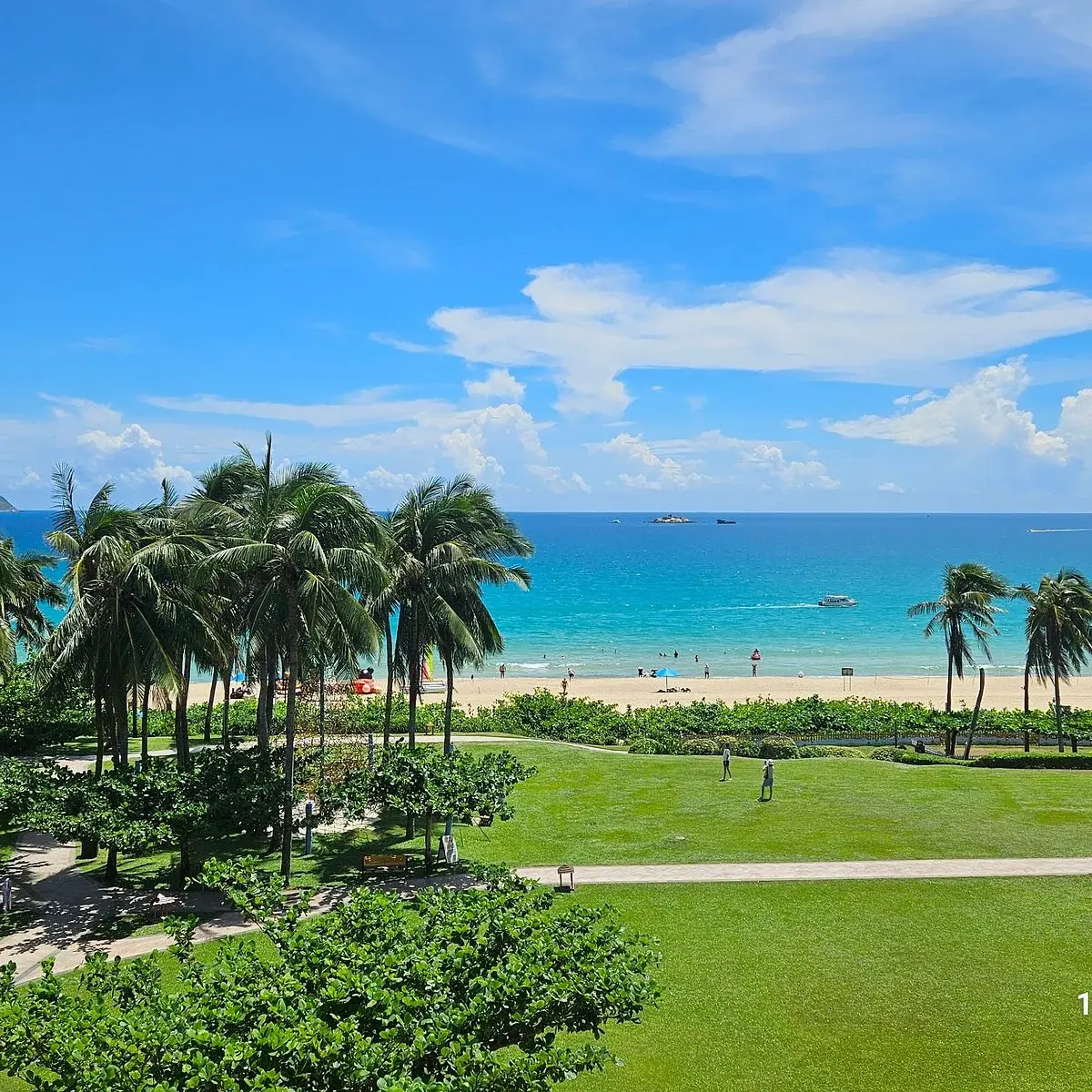 Turquoise water and palm trees along Yalong Bay beach in Sanya, Hainan