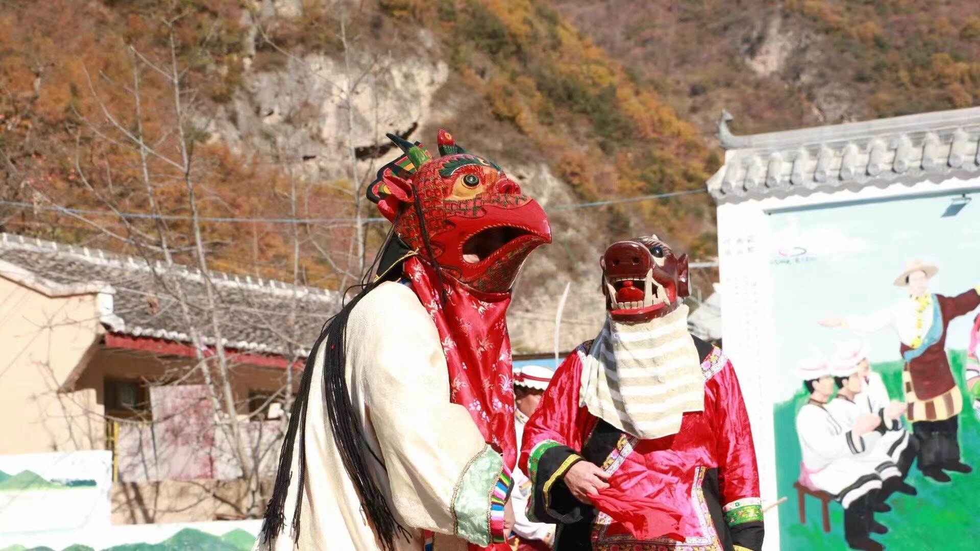 A Baima dancer in a shaggy panda costume mid-step in a village square, mountains behind