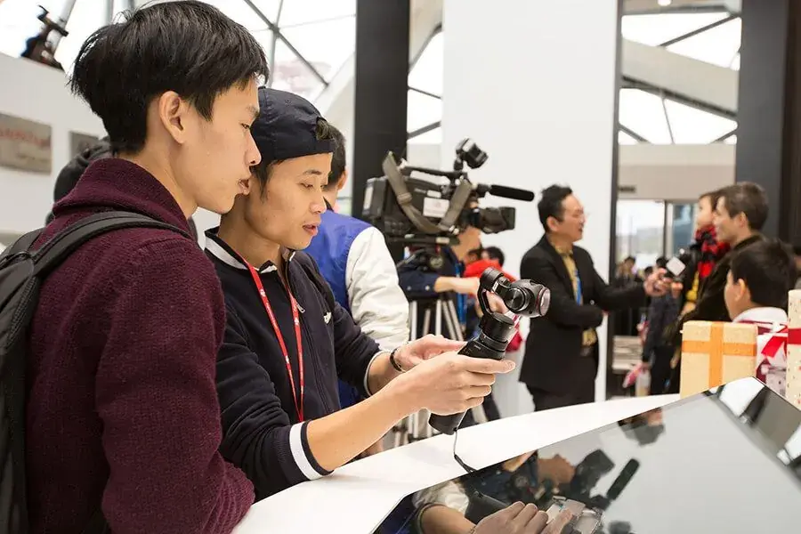 Visitors handling products at the store counter
