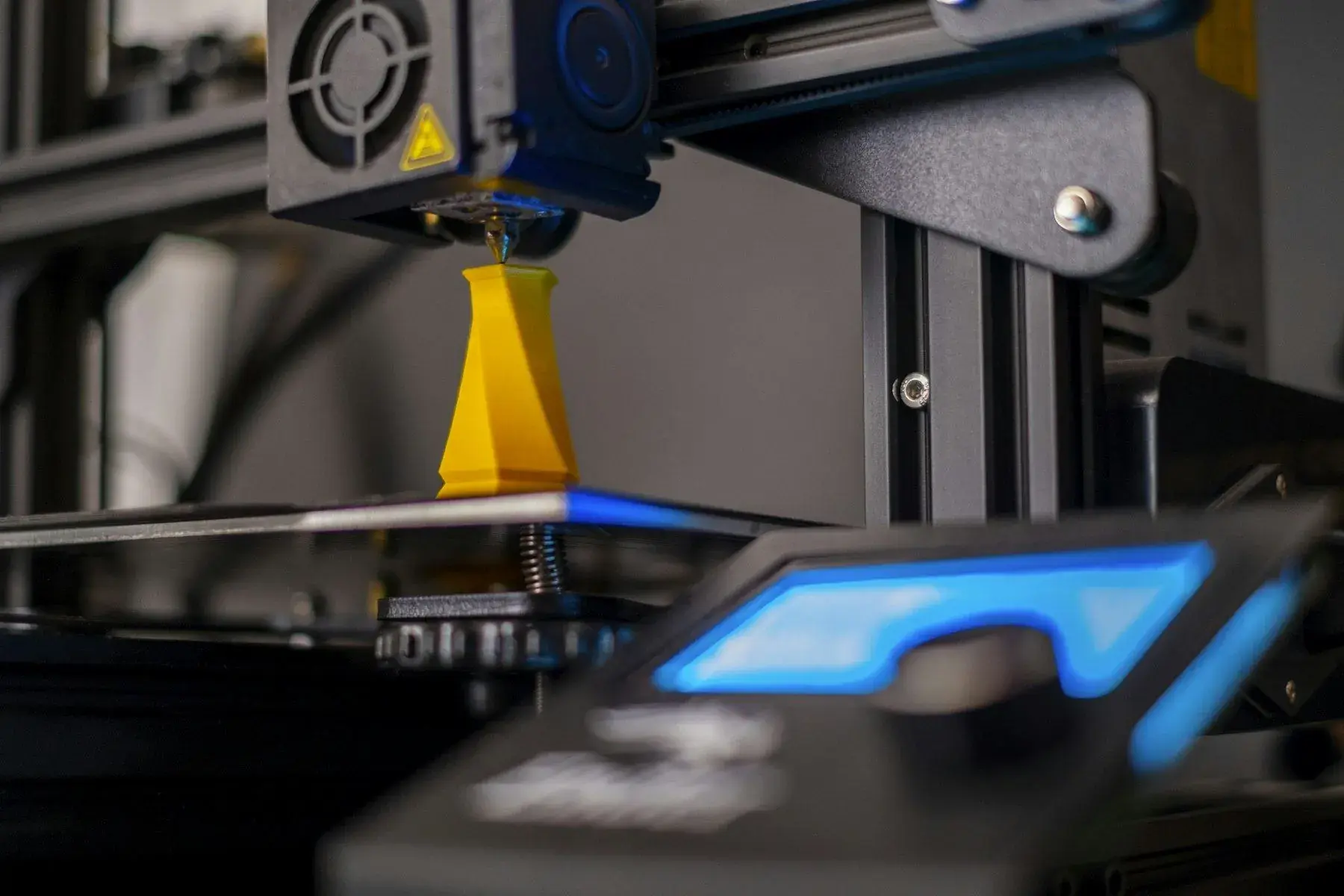 A 3D printer nozzle laying down filament