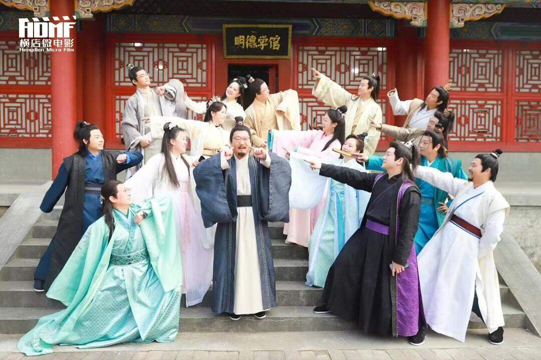 A group of visitors in period costume laughing together in front of palace steps