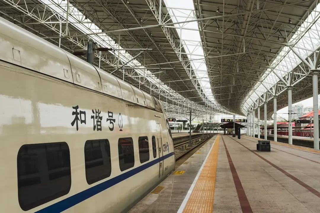A high-speed train waiting at a Chinese railway station platform