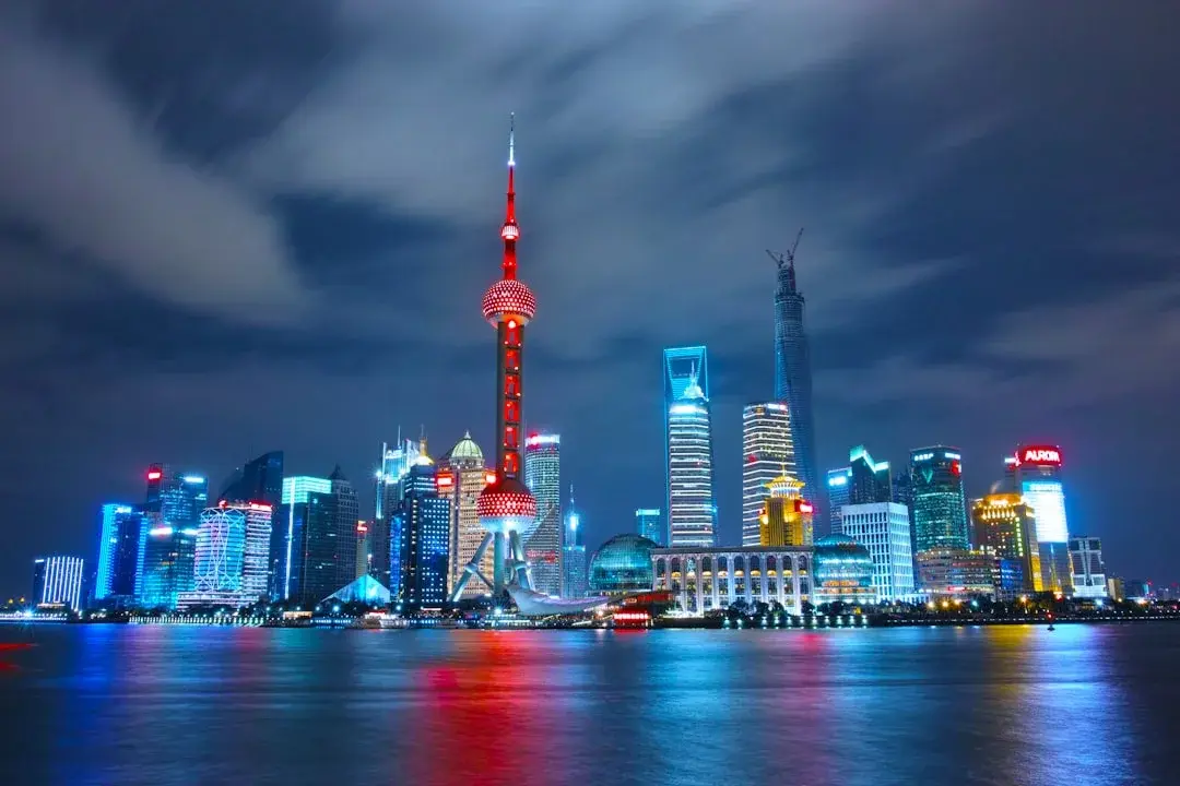 The Bund waterfront at dusk with Shanghai's Pudong skyline glowing across the river