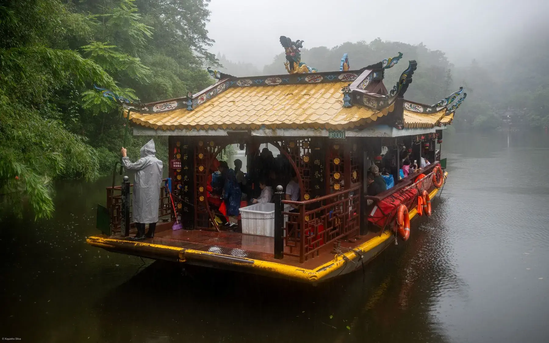A ferry crossing the lake on Mount Qingcheng in mist
