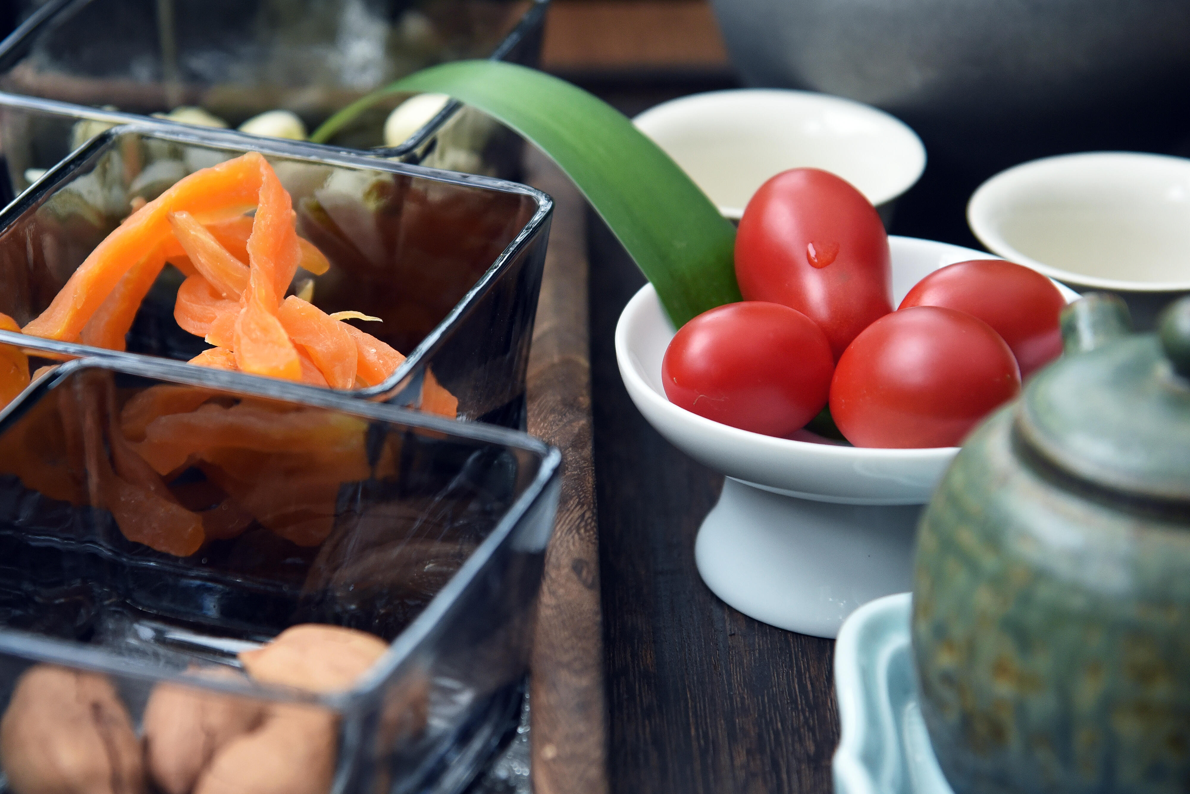Fresh mountain snacks on a tea table, cherry tomatoes, walnuts and candied fruit