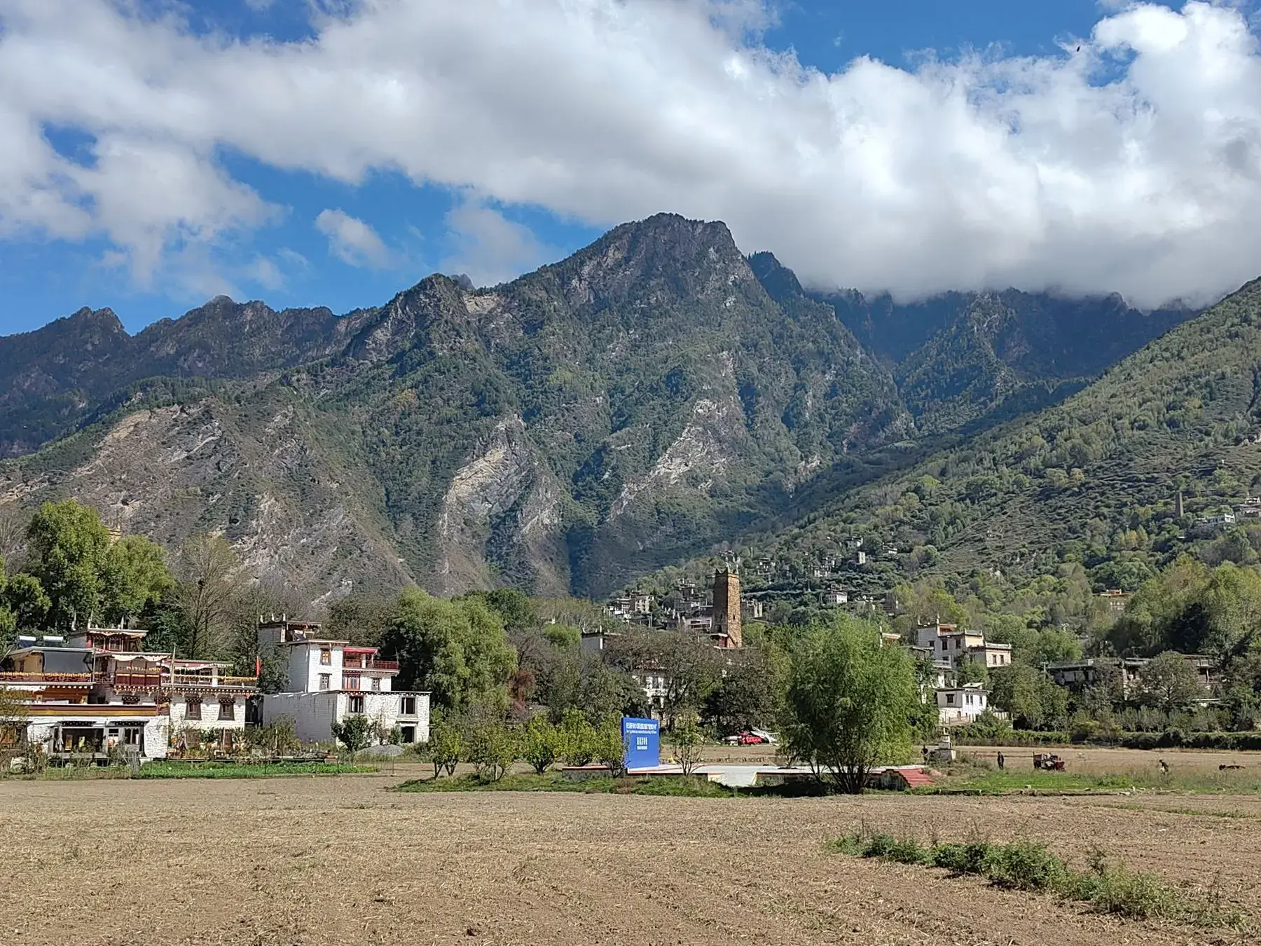 A mountain village of timber and stone houses in a low valley