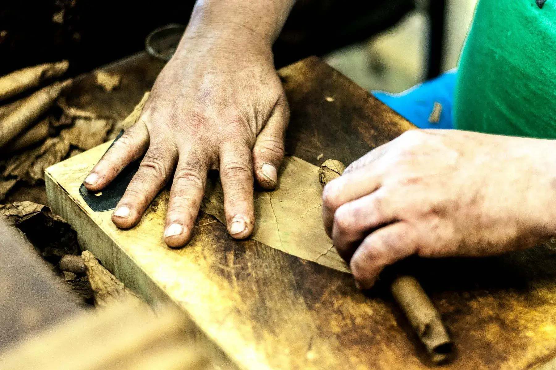 Hands cutting leather
