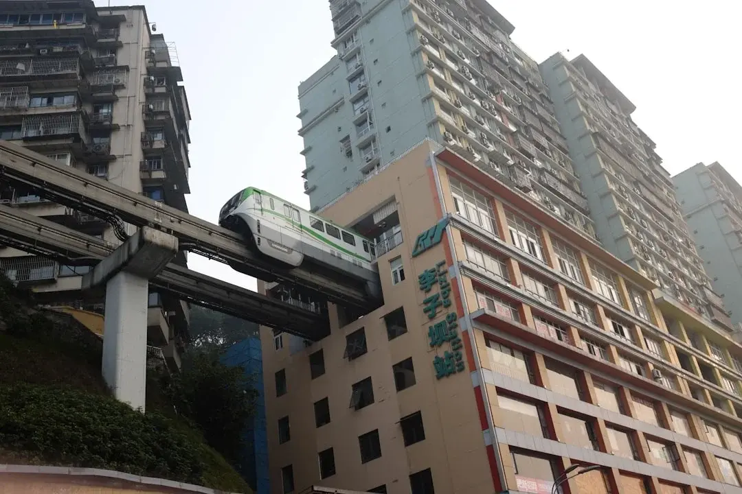 A Chongqing light-rail train passing through a residential building at Liziba station