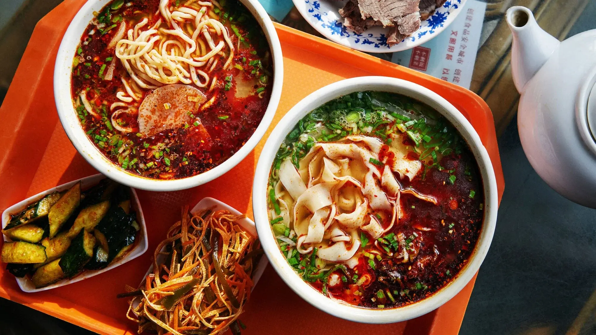 A bowl of Lanzhou hand-pulled beef noodles with clear broth and chilli oil
