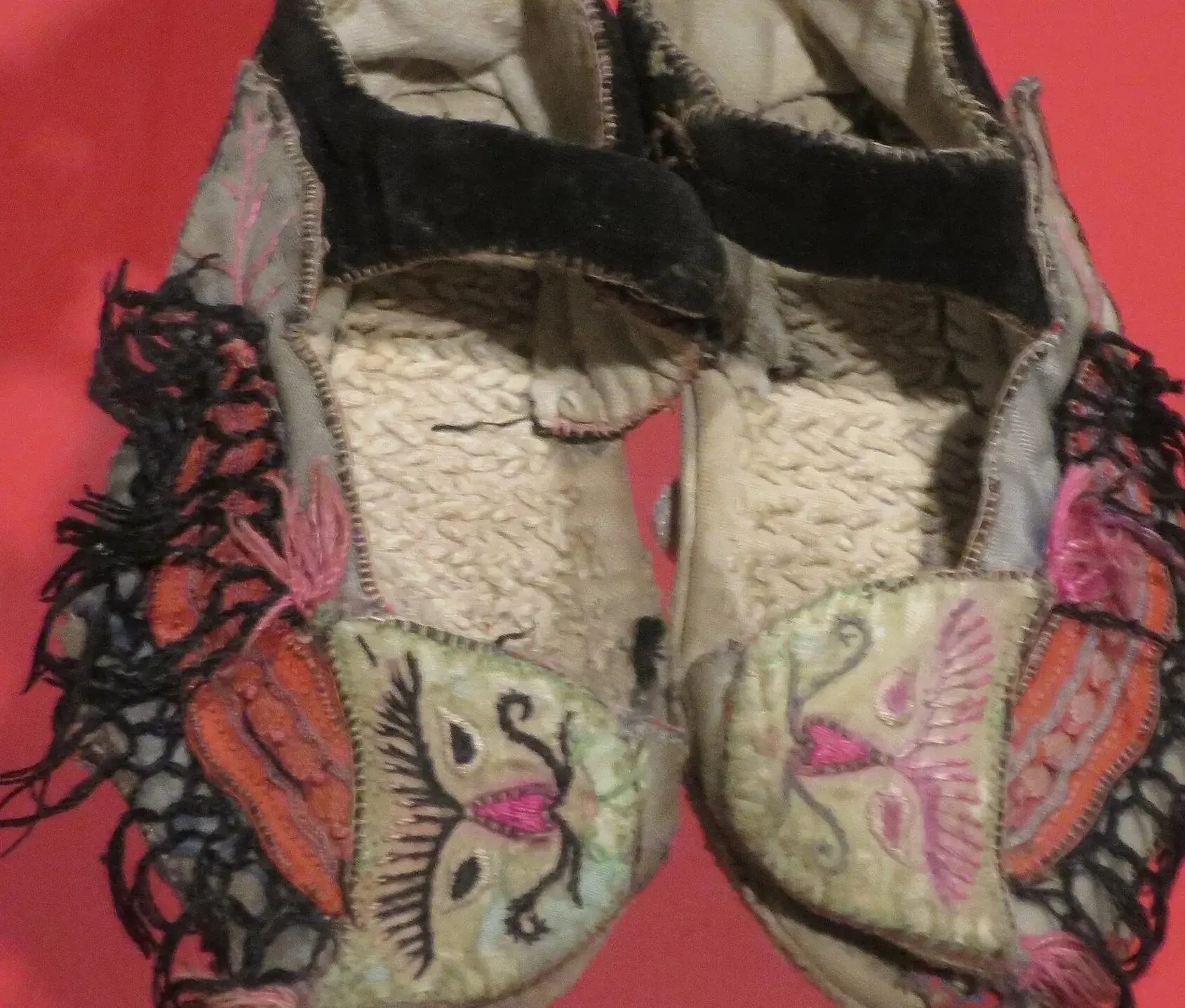 Hand stitching and appliqué on an antique cloth shoe