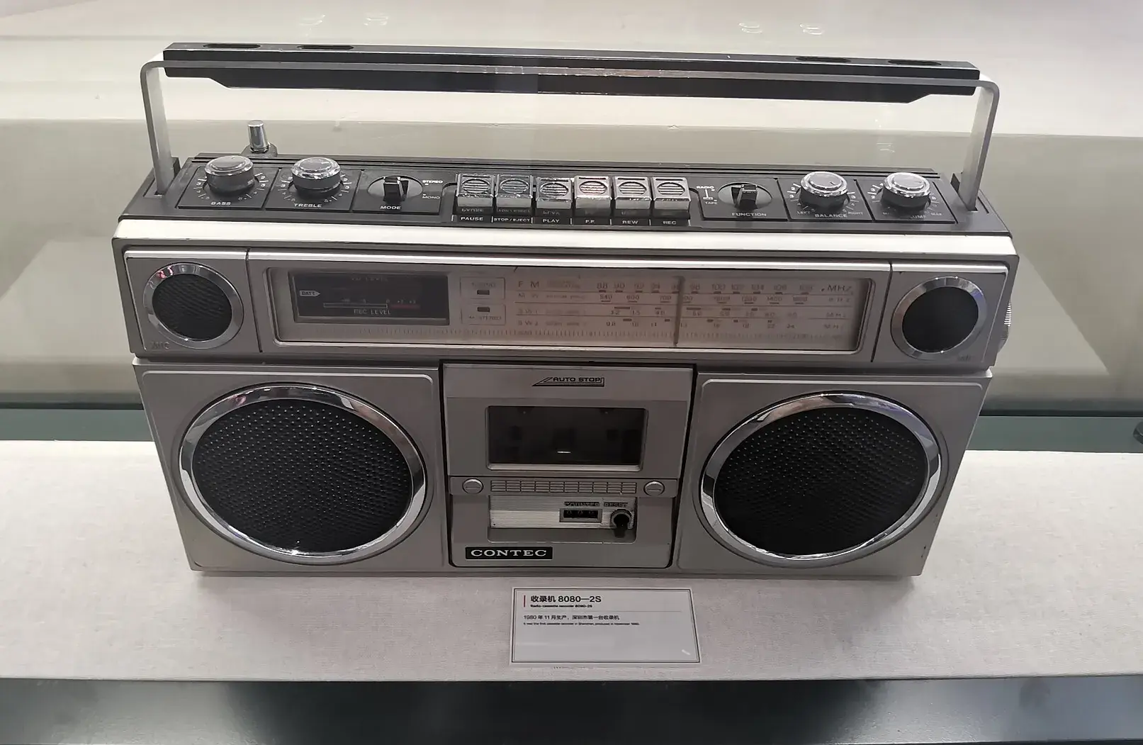 A vintage cassette radio in a display case at the Huaqiangbei museum