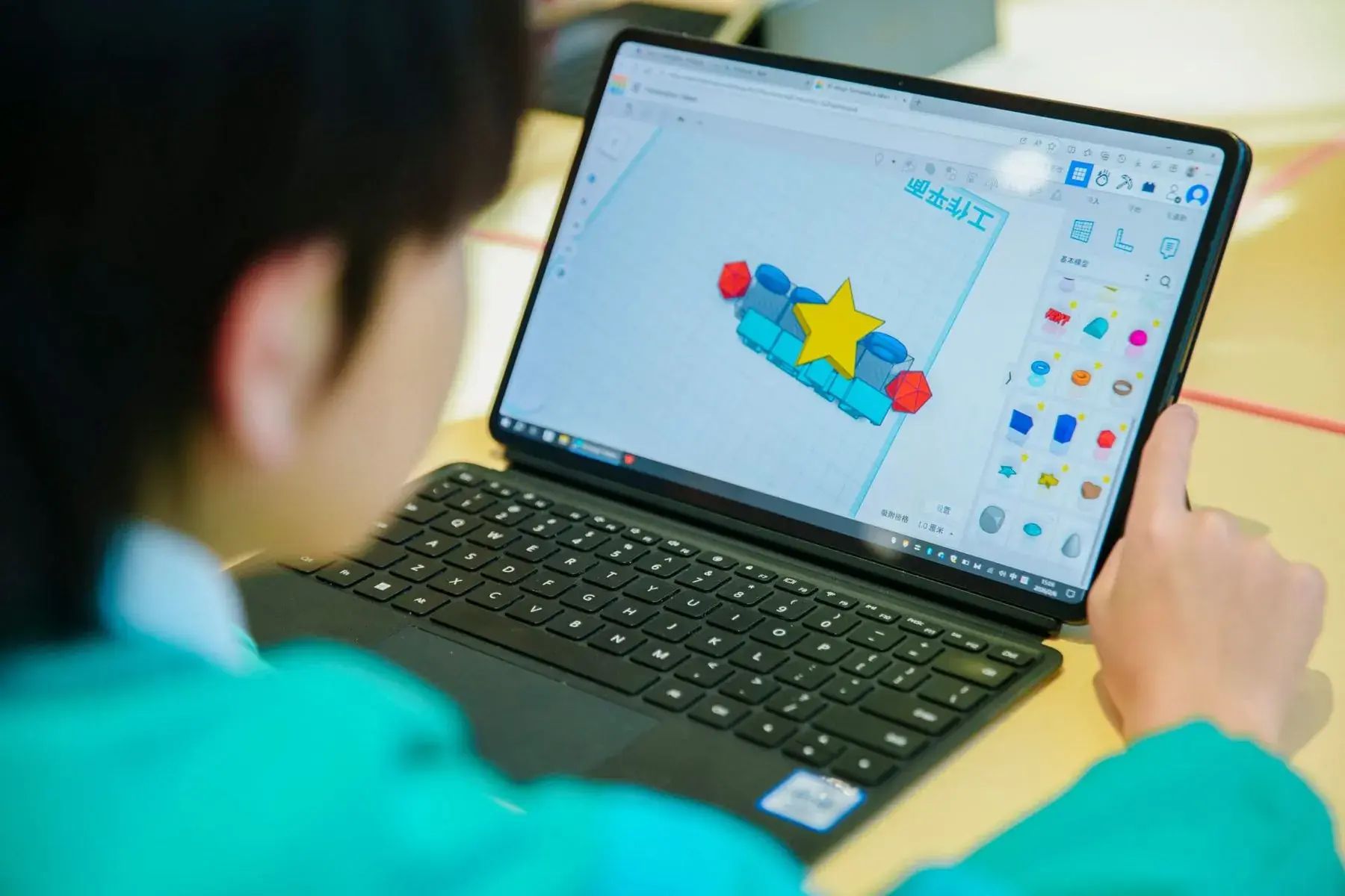 A three-dimensional model on a laptop screen at the printing centre