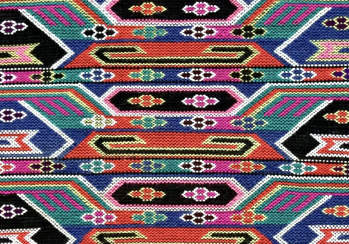 The weave at close range, every motif resolved into individual square colour blocks