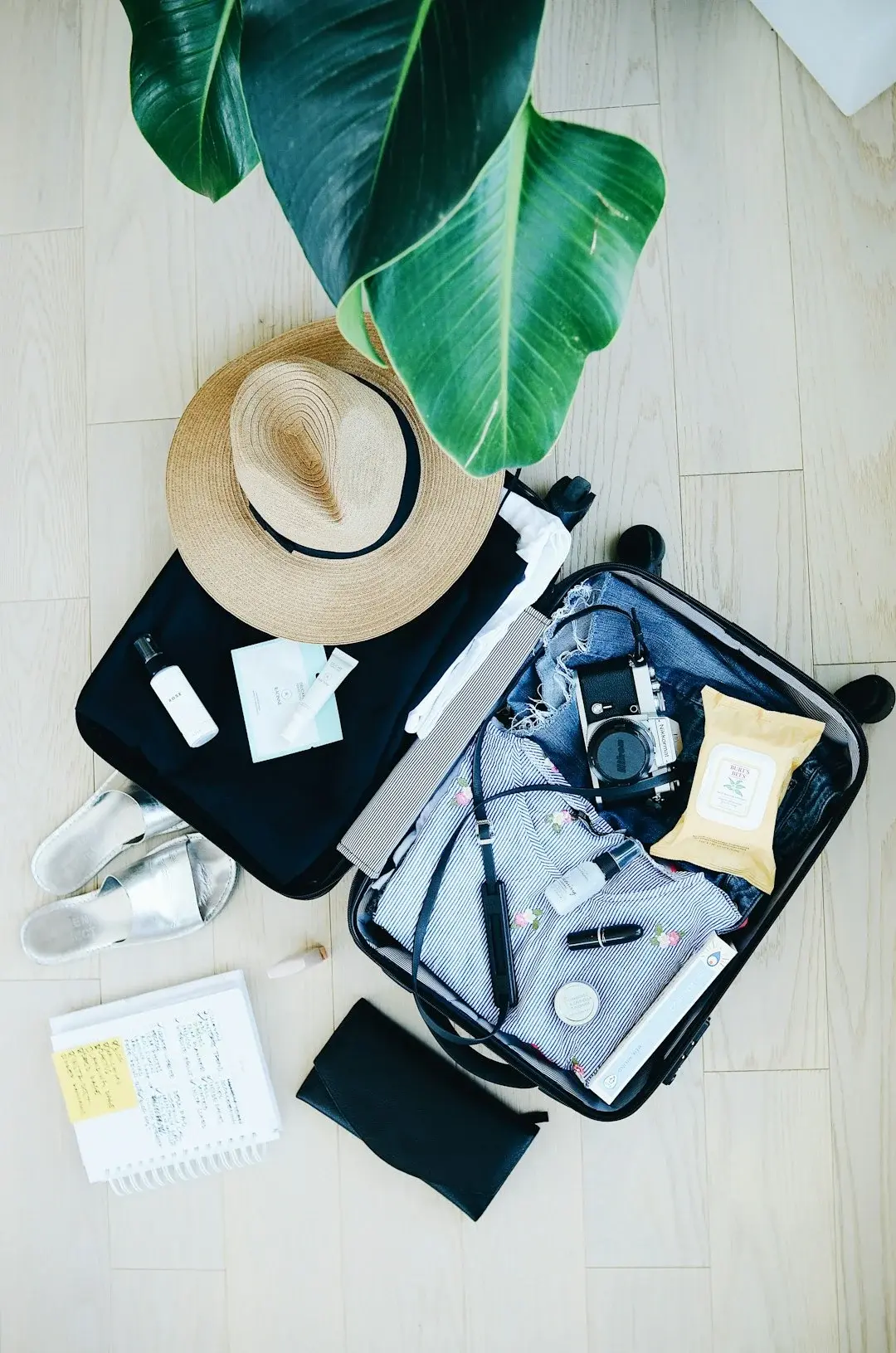 A neatly packed carry-on suitcase and travel backpack ready for a trip