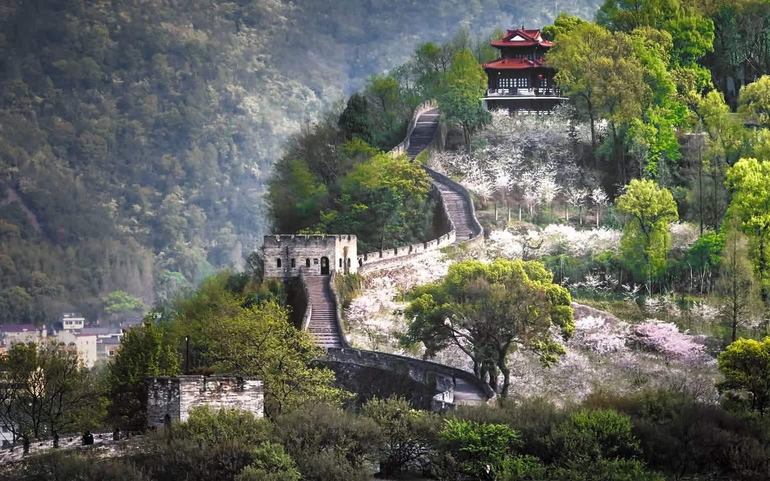 The Taizhou Prefecture Wall in spring, its gatehouse and flowering trees running along the ridge