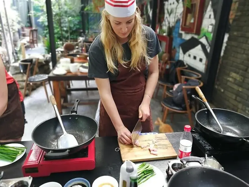 A guest cooking at a wok station