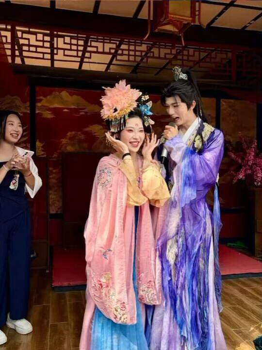 A couple in hanfu against a period-style set