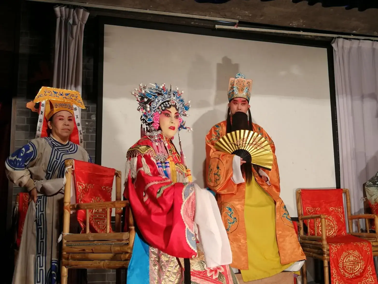 Two Sichuan opera performers on stage in full costume