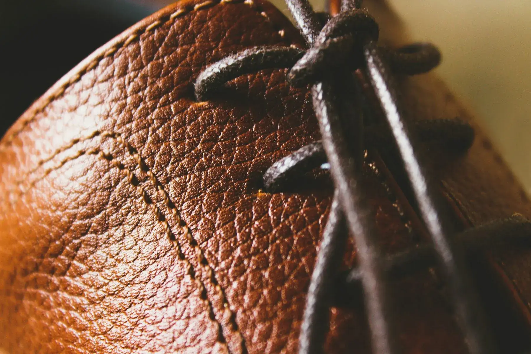 An awl piercing leather ready for stitching
