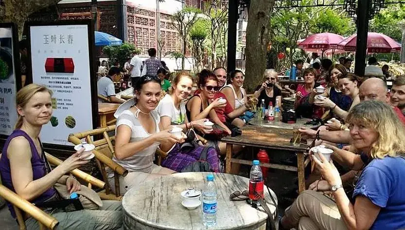 Guests seated at the outdoor teahouse tables in the park