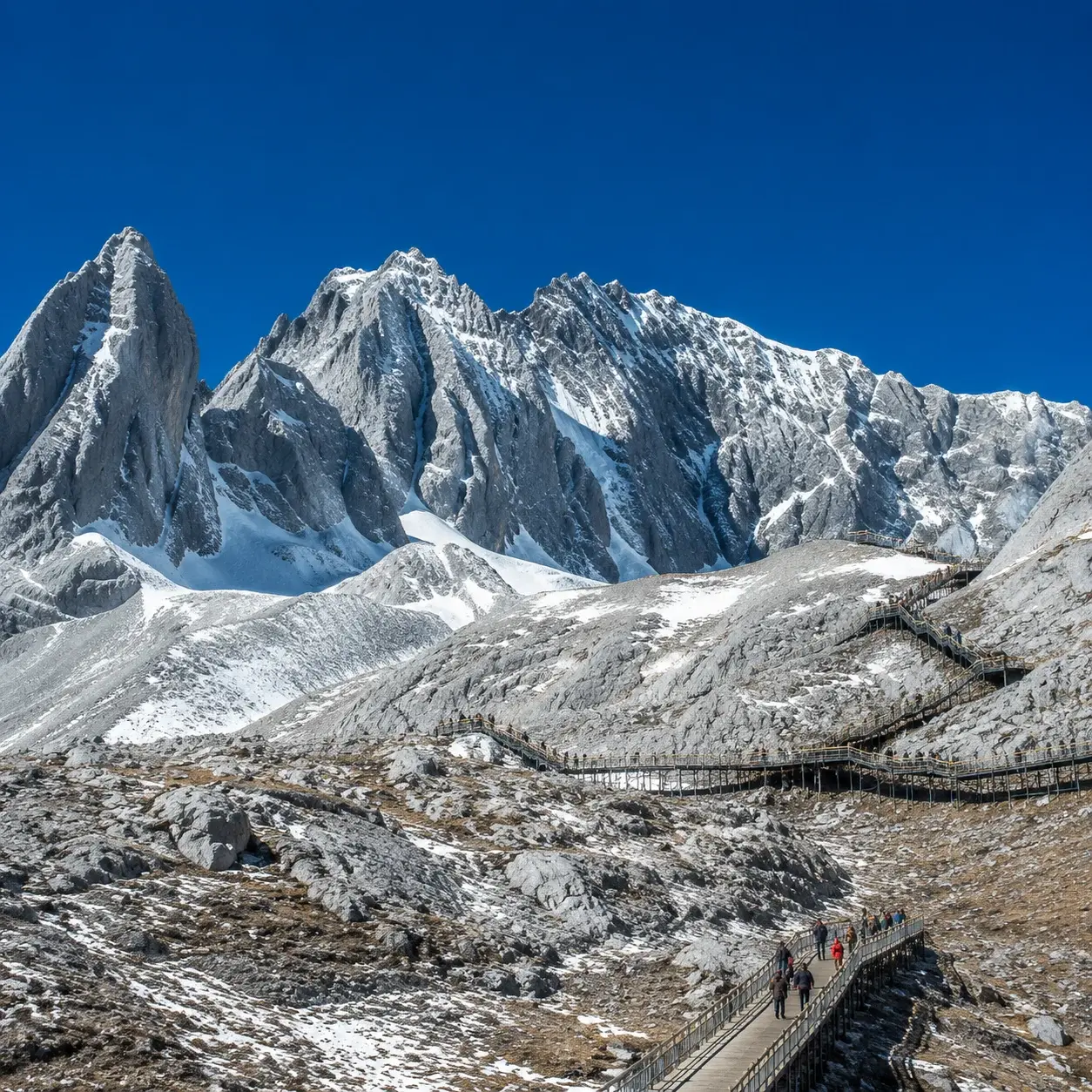 Snow-covered peaks of Jade Dragon Snow Mountain above a high-altitude boardwalk
