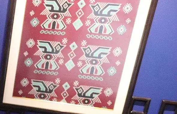 A framed xilankapu pattern on the workshop wall