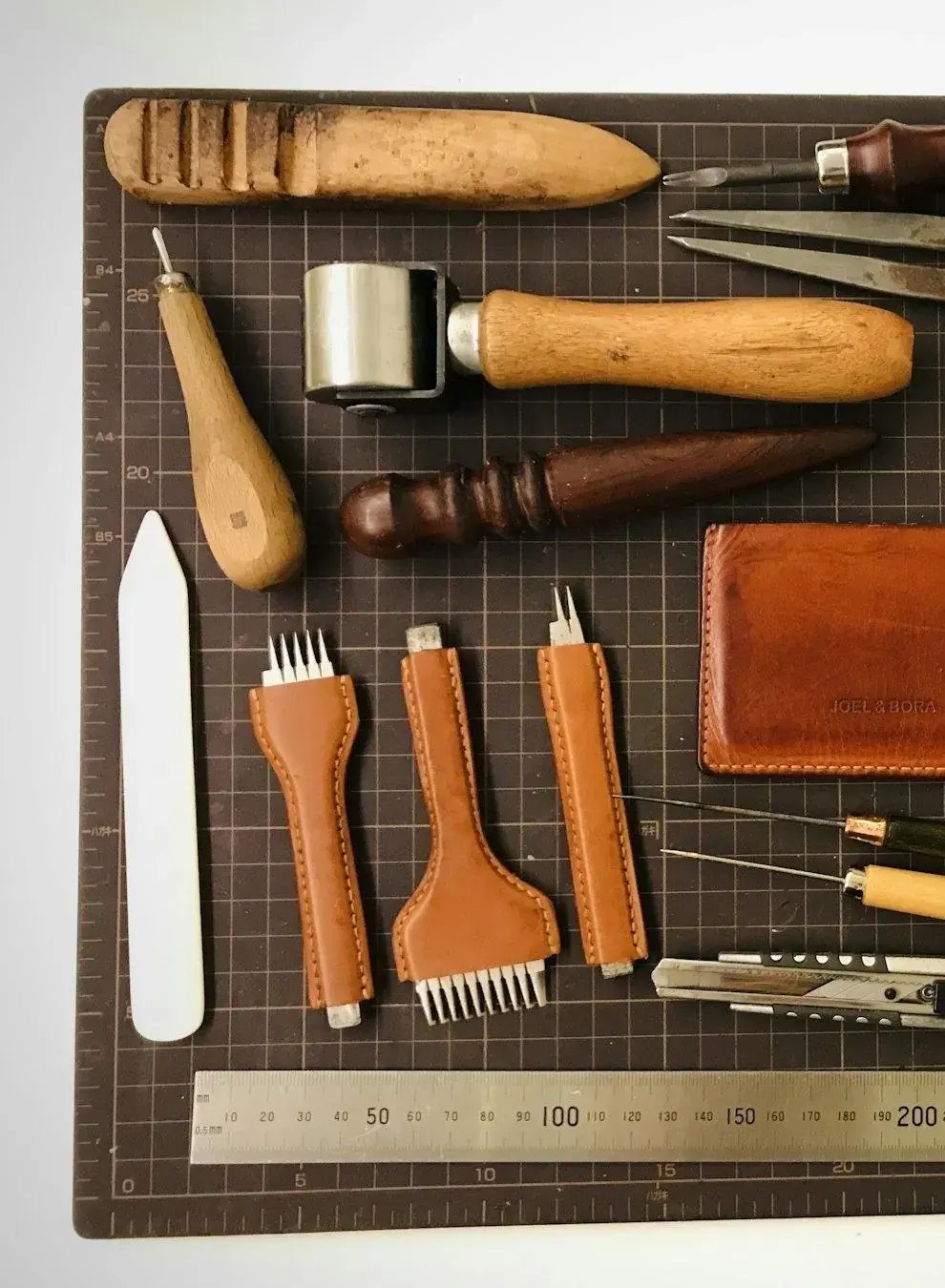Leather knives and edge tools laid out on the bench