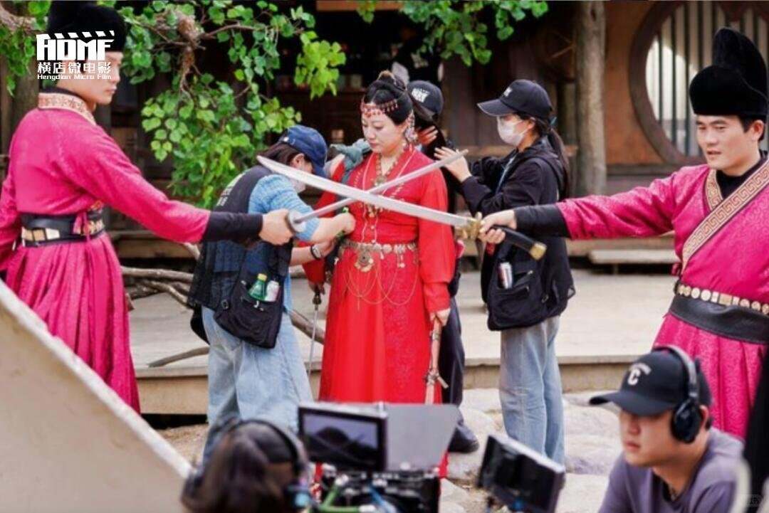 A crew filming a visitor in period costume on set