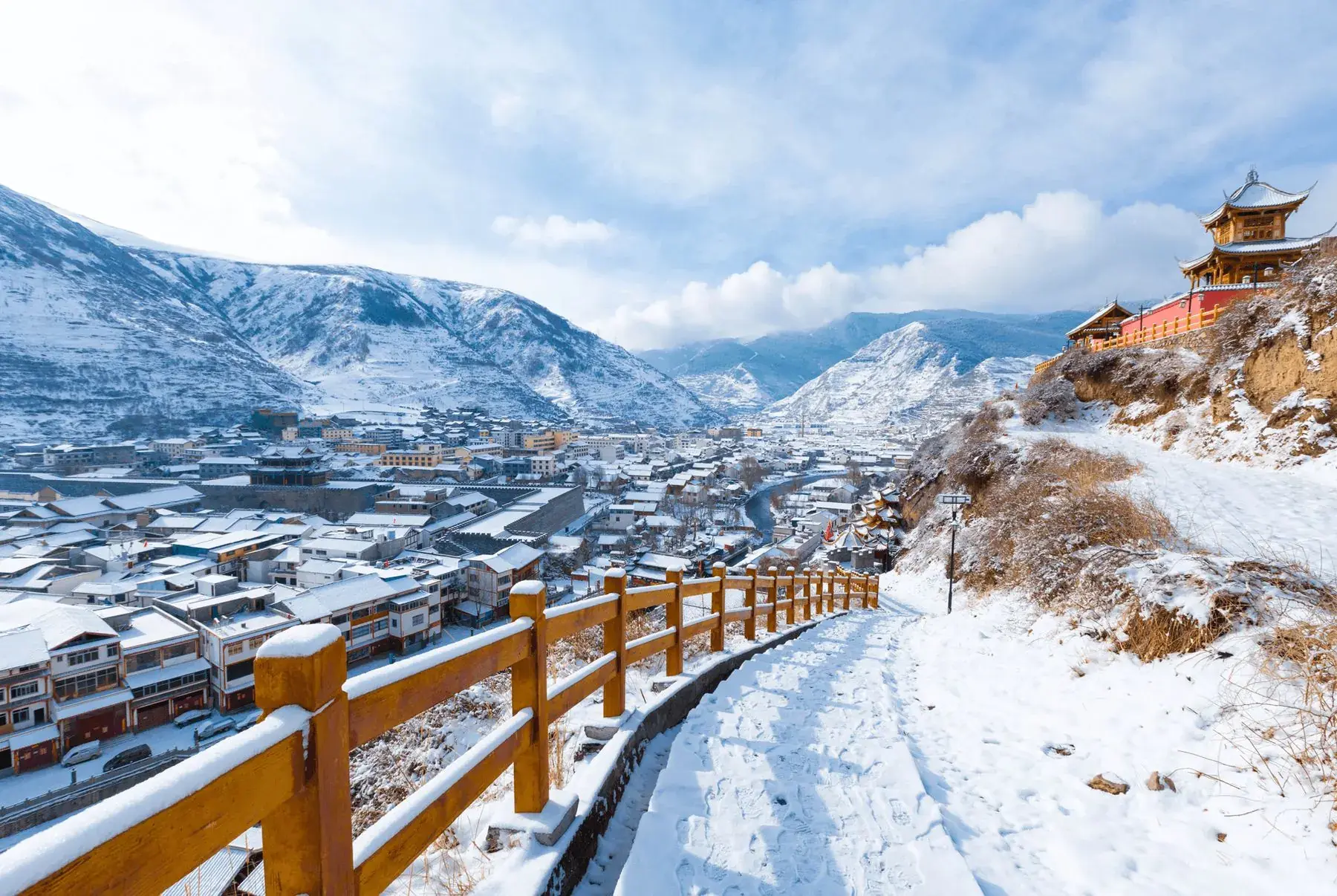 A boardwalk under snow in the mountains near Songpan