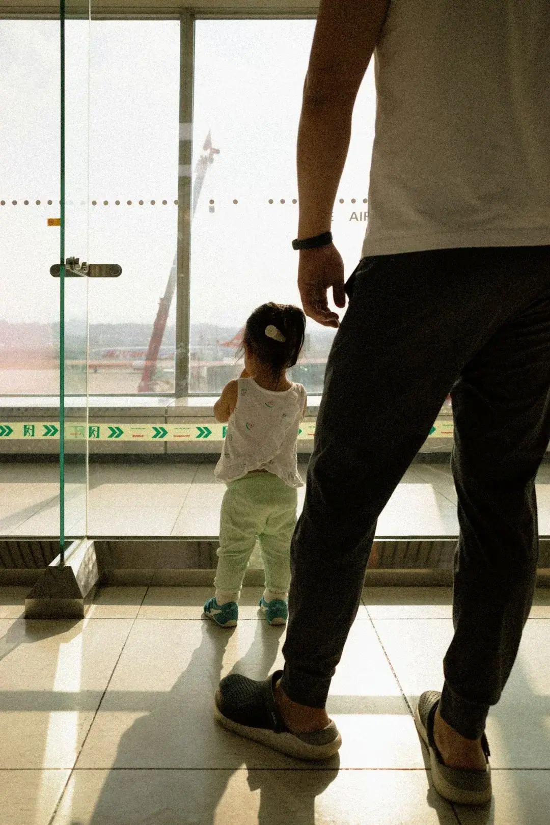 A family with luggage in a bright modern airport departure hall