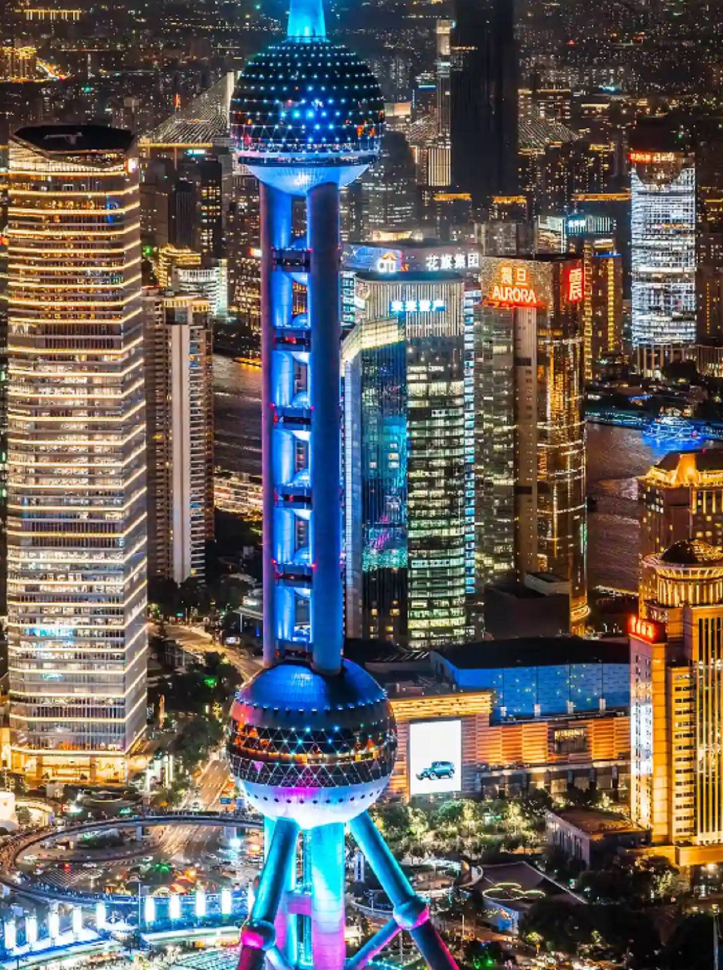 The Oriental Pearl at night, close, with towers around it