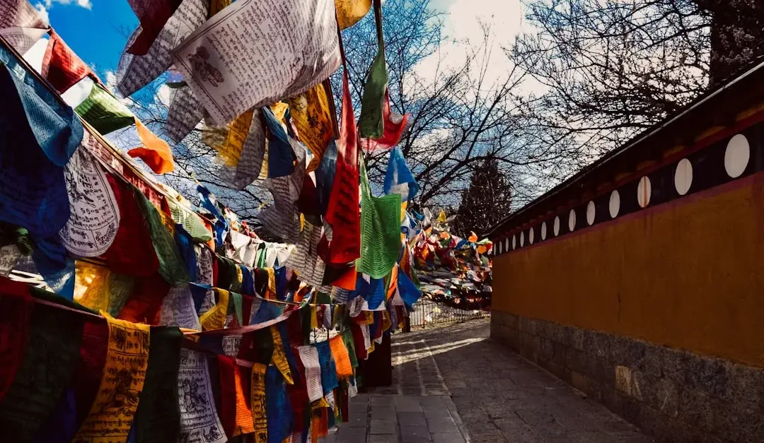 Colourful prayer flags strung across a Tibetan Buddhist monastery