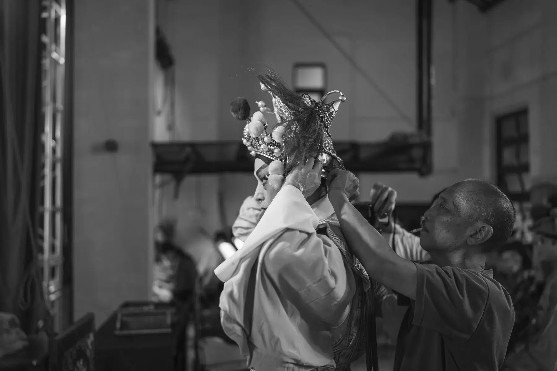 A headdress being fitted backstage