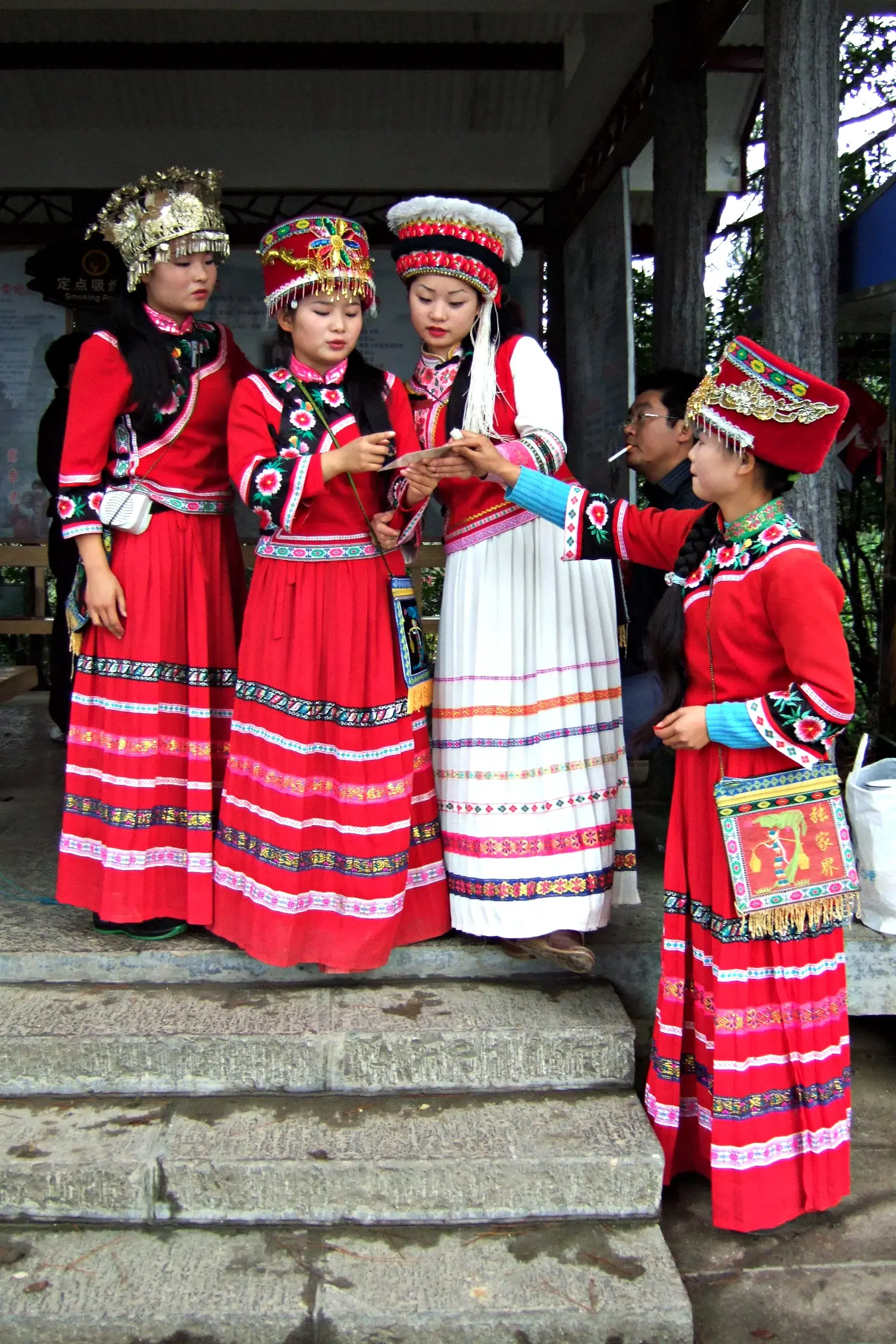 Women in Tujia dress on the steps of the old town