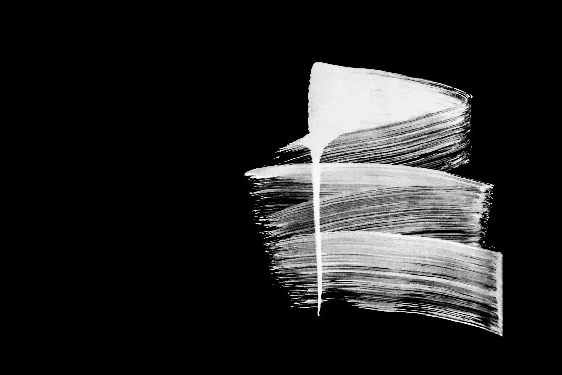 A single white brush stroke on black