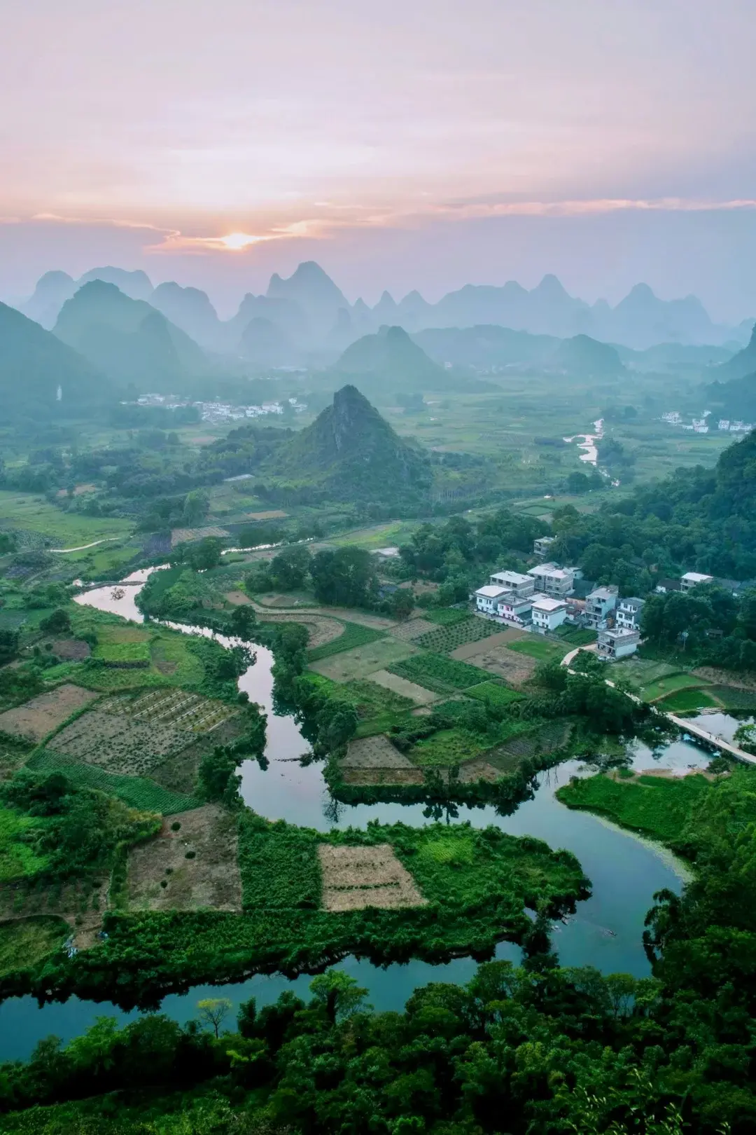 Karst mountains reflected in the Li River near Guilin in soft light