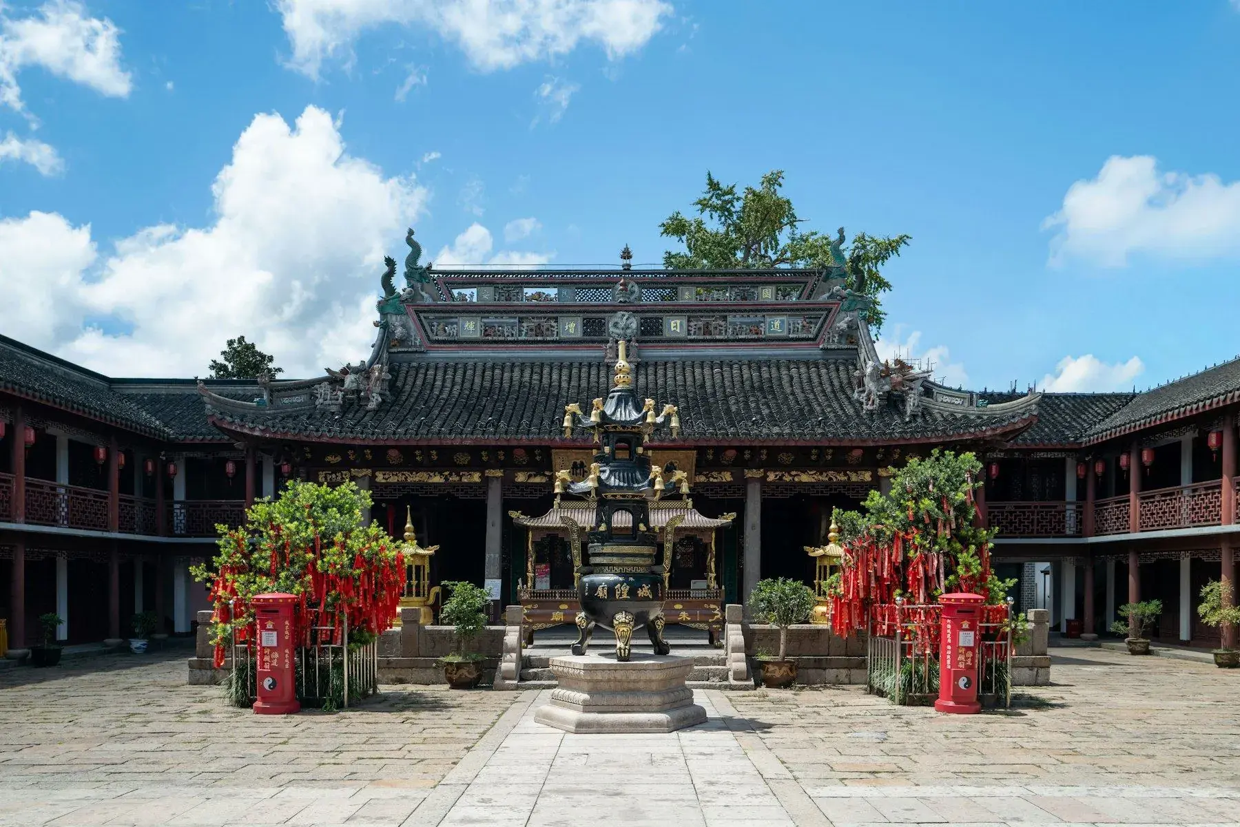 A Chinese temple courtyard with incense burning