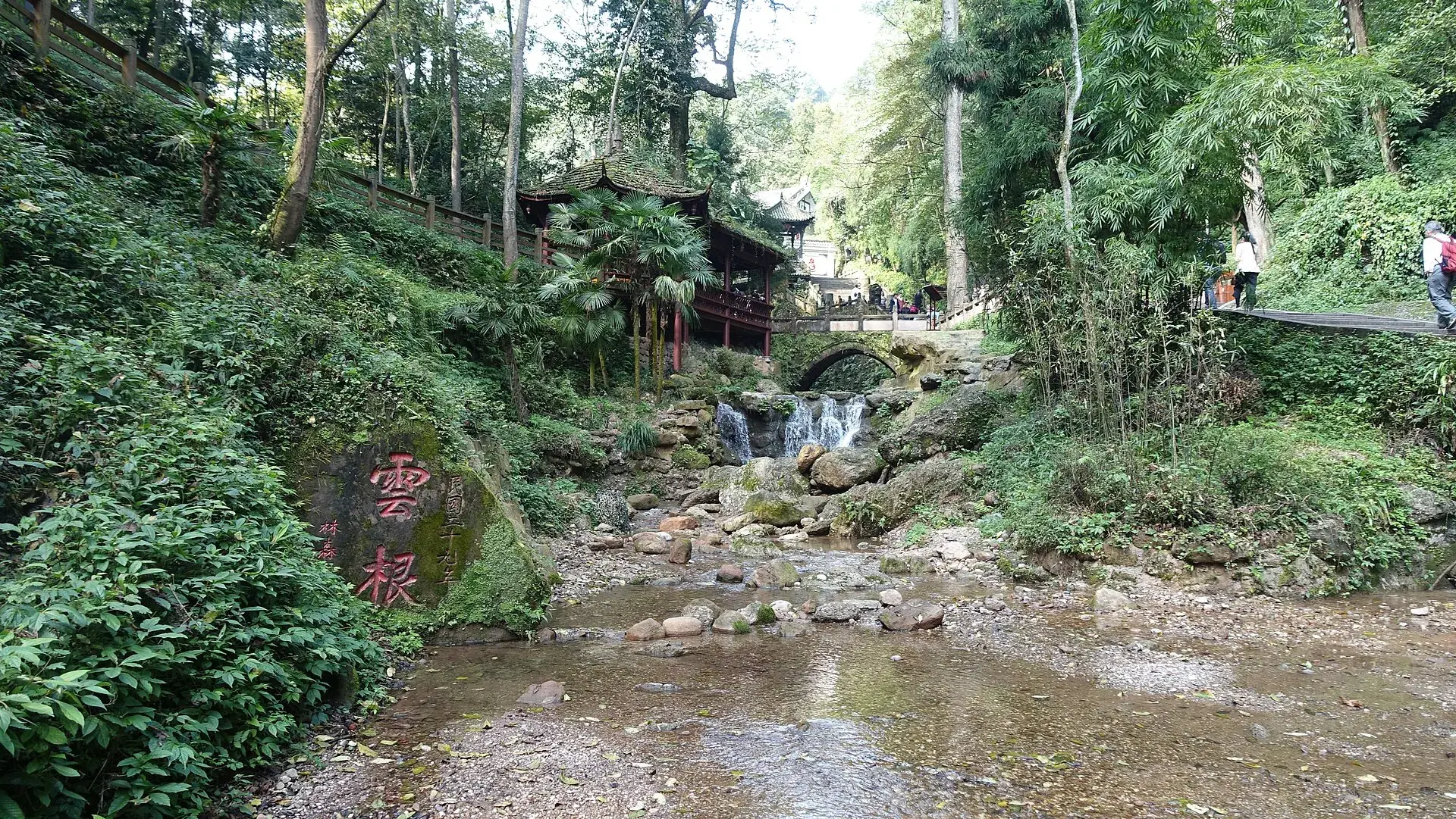 The stream in the ravine the bridge crosses, under the rock inscription