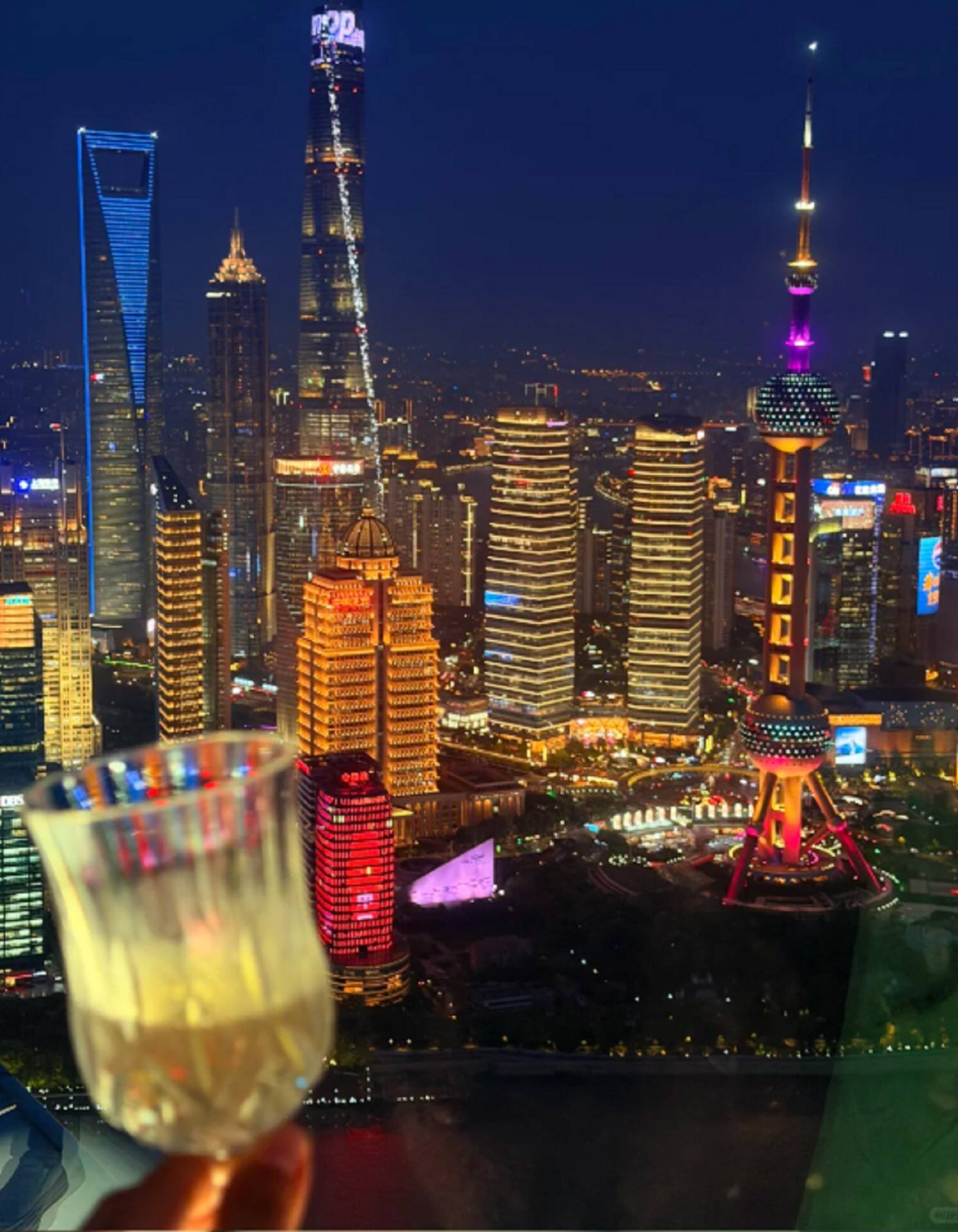 Lujiazui at night from above, a glass in the foreground