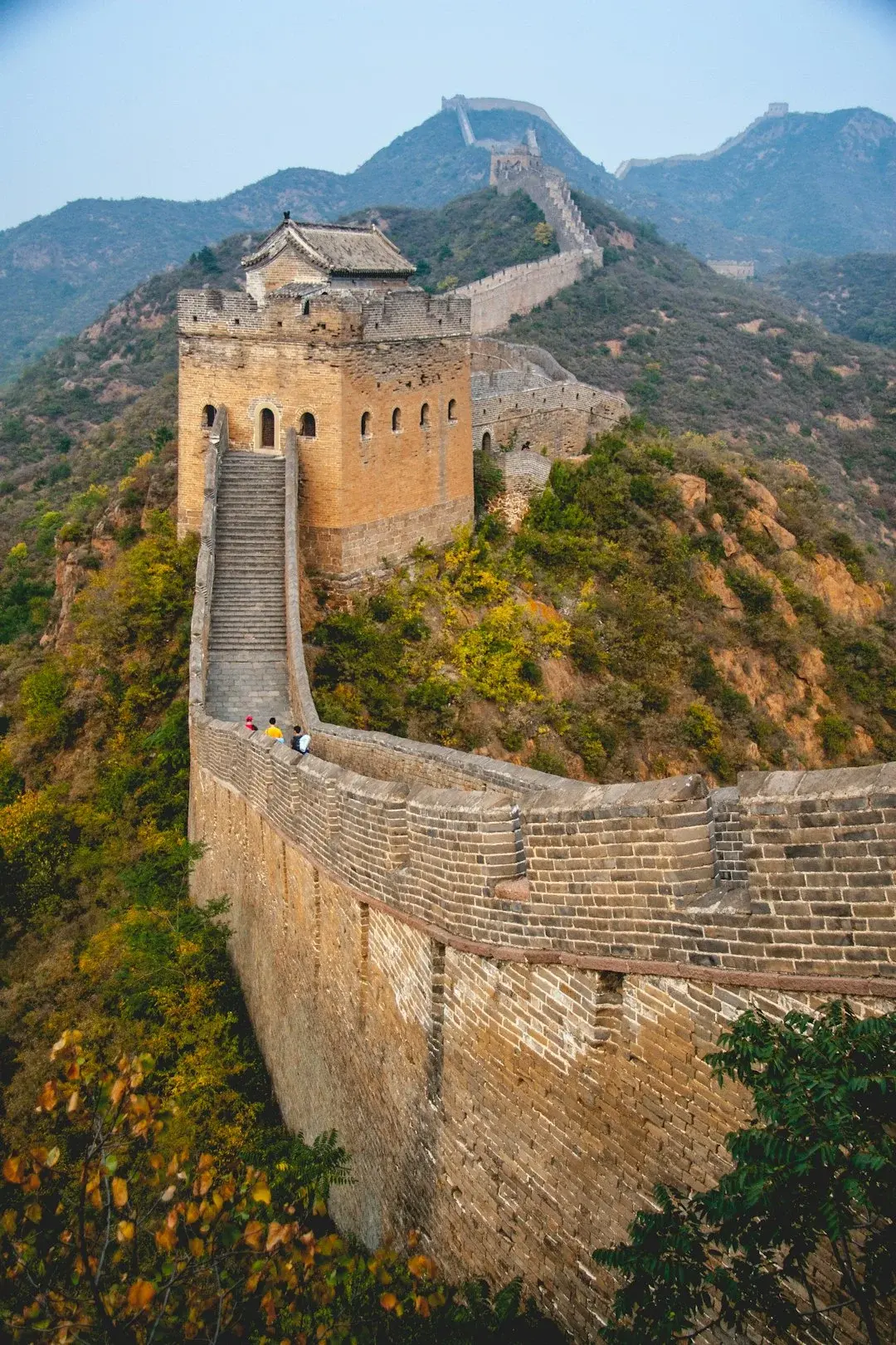 A family with young children walking along the Great Wall of China