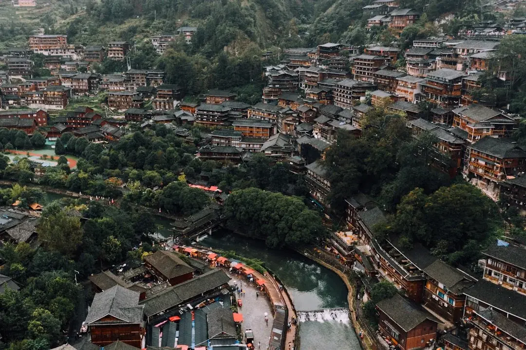 A traditional multi-tiered Dong drum tower rising above Zhaoxing village in Guizhou
