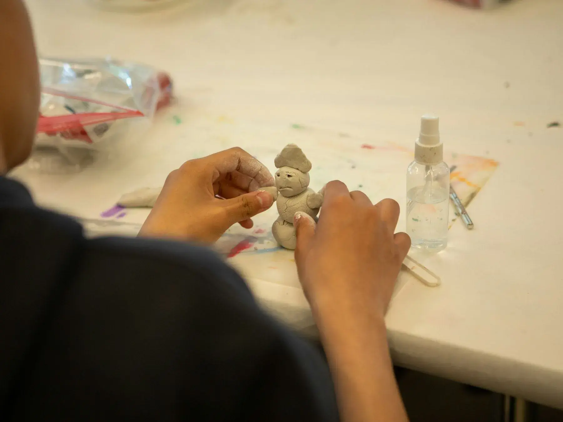 Hands painting a small figure