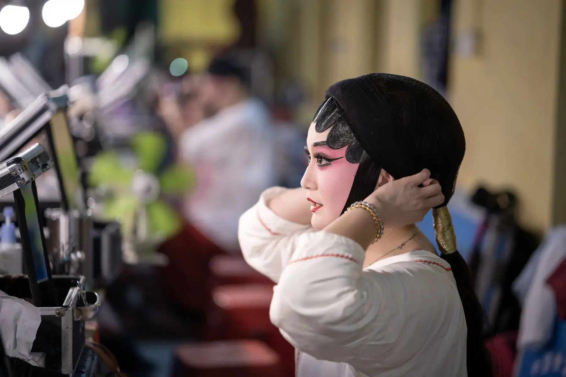 A Sichuan opera performer in full costume and painted face