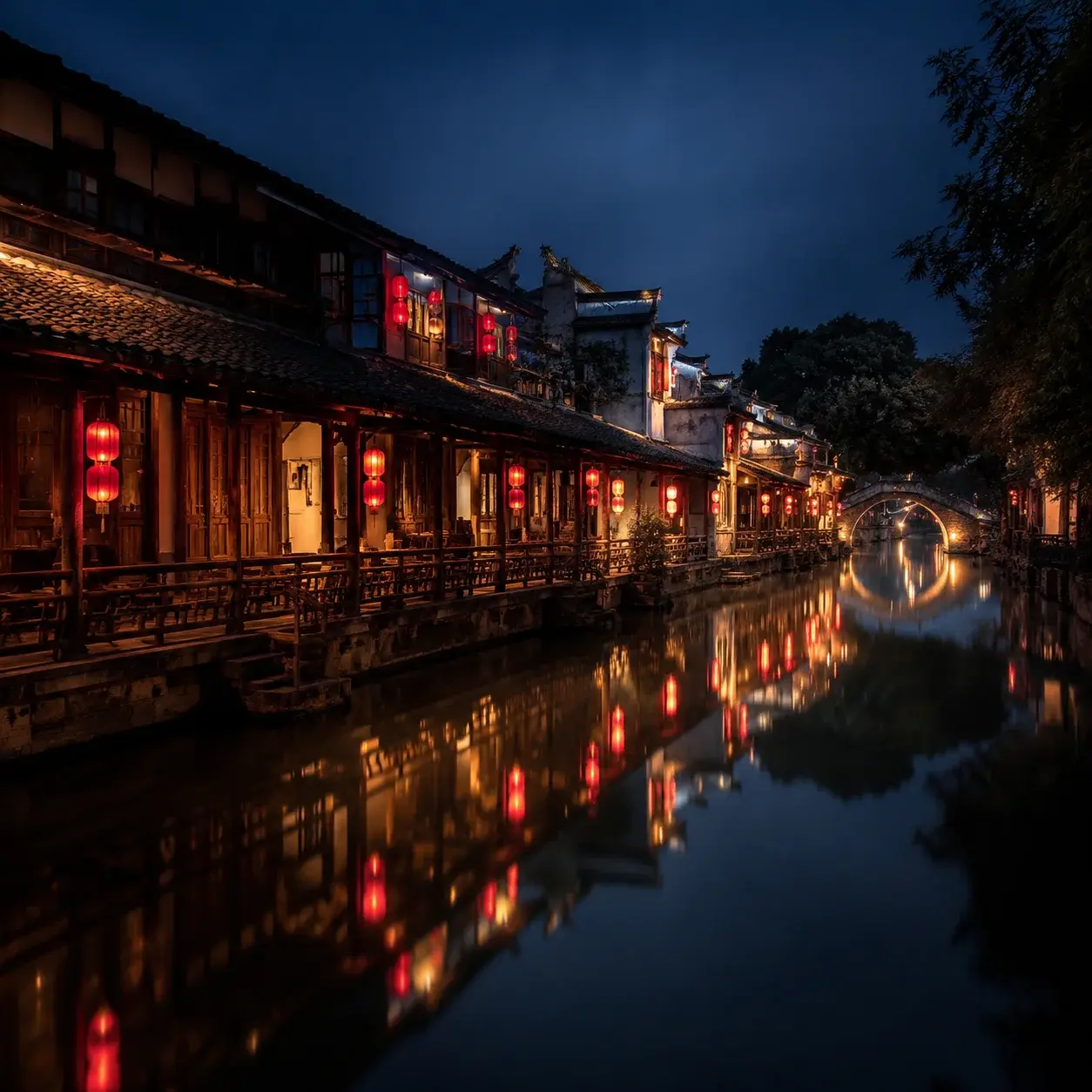 Lantern-lit canal reflections at night in Xitang water town