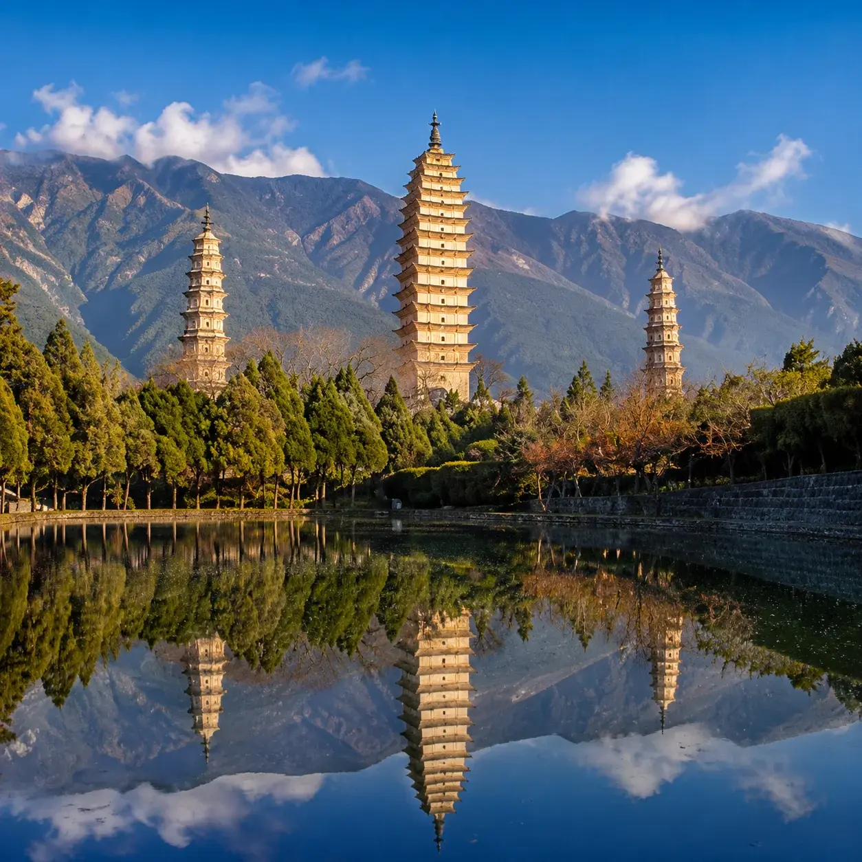 The Three Pagodas of Chongsheng Temple reflected in a pond below Cangshan