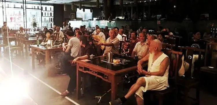 A traditional teahouse packed with people at wooden tables