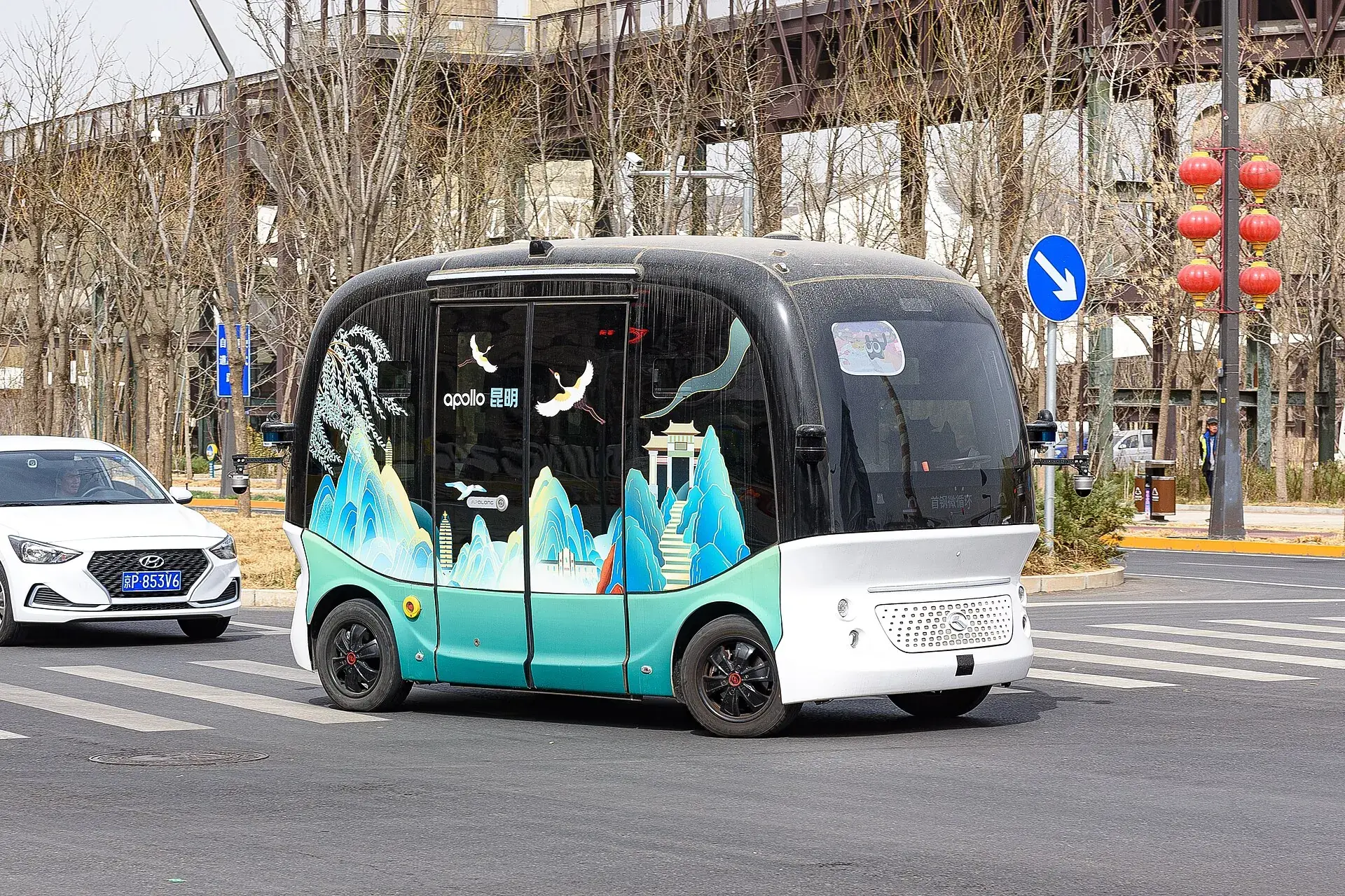 A driverless shuttle giving way at a crossing